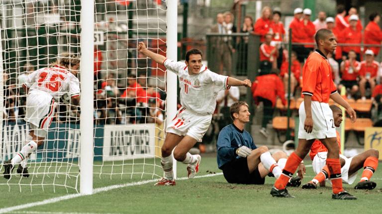 SAINT-ETIENNE, FRANCE - JUNE 25: Luis Hernandez of Mexico (15) picks up the ball after scoring a last minute equaliser as teammate Cuauhtemoc Blanco (centre) celebrates during the 1998 FIFA World Cup Group E match between the Netherlands and Mexico at the Stade Geoffroy-Guichard on June 25, 1998 in Saint-Etienne, France. (Photo by Paul Popper/Popperfoto via Getty Images/Getty Images)