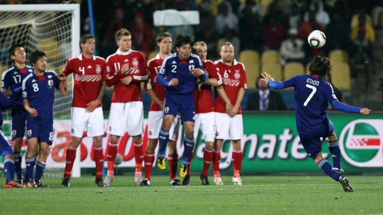 RUSTENBURG, SOUTH AFRICA - JUNE 24:  Yasuhito Endo of Japan (R) scores his team's second goal from a free kick during the 2010 FIFA World Cup South Africa Group E match between Denmark and Japan at the Royal Bafokeng Stadium on June 24, 2010 in Rustenburg, South Africa.  (Photo by Ian Walton/Getty Images)