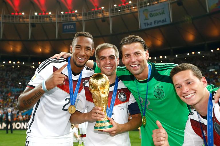 Football - Germany v Argentina - FIFA World Cup Brazil 2014 - Final - Estadio do Maracana, Rio de Janeiro, Brazil - 13/7/14..Actionshot, Germany's Jerome Boateng, Philipp Lahm, Ron Robert Zieler and Julian Draxler celebrate winning The World Cup with the trophy..Mandatory Credit: Action Images / Andrew Boyers..