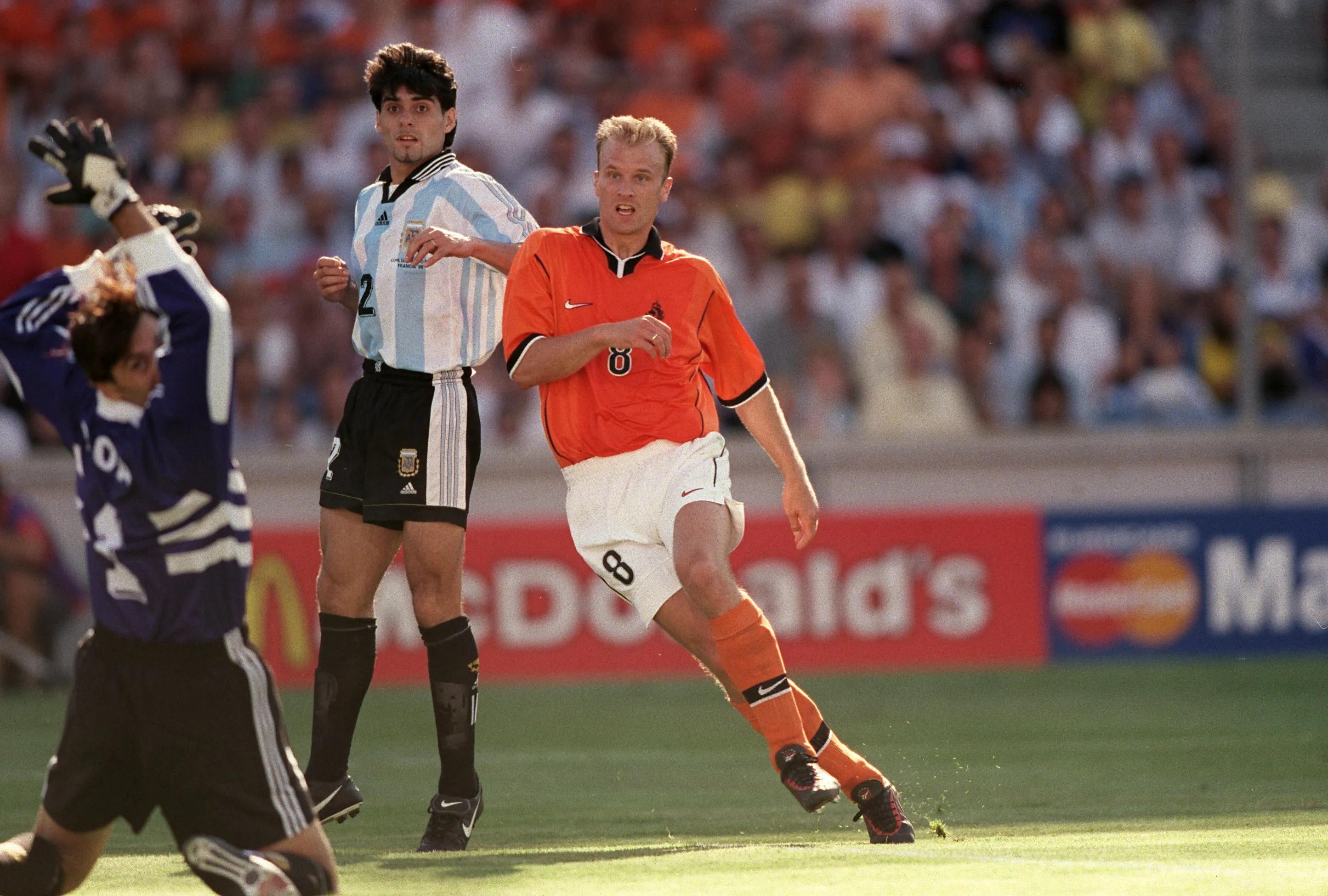 Netherlands' Dennis Bergkamp scores the winning goal past Argentina goalkeeper Carlos Roa in 1998 FIFA