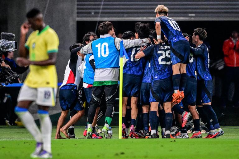 Japan's players celebrate after scoring a goal during the international football friendly match between Japan and Brazil at the Tokyo stadium in Chofu, Tokyo prefecture on October 14, 2025. (Photo by Yuichi YAMAZAKI / AFP) (Photo by YUICHI YAMAZAKI/AFP via Getty Images)