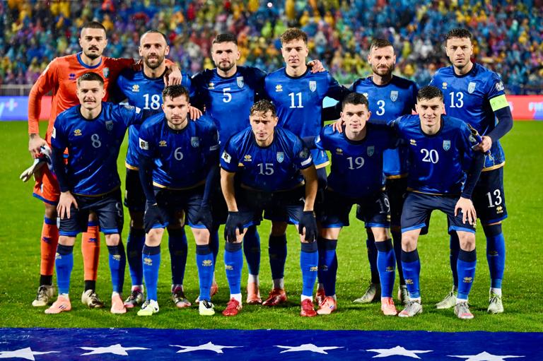 (Top L-R) Kosovo's goalkeeper #01 Arijanet Muric, Kosovo's forward #18 Vedat Muriqi, Kosovo's midfielder #05 Lumbardh Dellova, Kosovo's forward #11 Fisnik Asllani, Kosovo's defender #03 Fidan Aliti, Kosovo's defender #13 Amir Rrahmani, (bottom L-R) Kosovo's midfielder #08 Florent Muslija, Kosovo's midfielder #06 Elvis Rexhbecaj, Kosovo's defender #15 Mergim Vojvoda, Kosovo's defender #19 Dion Gallapeni and Kosovo's midfielder #20 Veldin Hodza pose prior to the FIFA World Cup 2026 European qualification Group B football between Kosovo and Switzerland at the Fadil Vokrri Stadium in Pristina, on November 18, 2025. (Photo by Armend NIMANI / AFP)