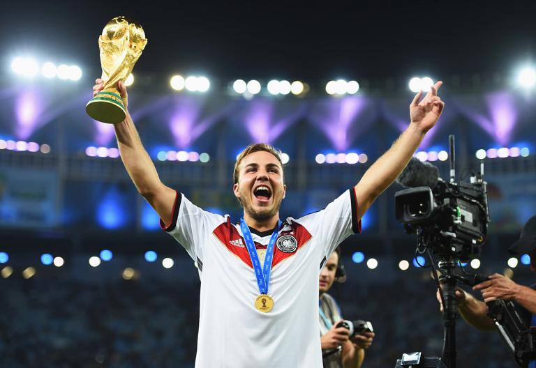 RIO DE JANEIRO, BRAZIL - JULY 13: Mario Goetze of Germany holds up the World Cup trophy after the 1-0 win in the 2014 FIFA World Cup Brazil Final match between Germany and Argentina at Maracana on July 13, 2014 in Rio de Janeiro, Brazil. (Photo by Shaun Botterill - FIFA/FIFA via Getty Images)