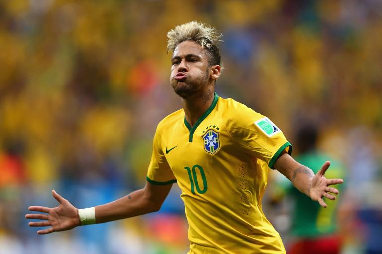 BRASILIA, BRAZIL - JUNE 23: Neymar of Brazil celebrates scoring his team's second goal and his second of the game during the 2014 FIFA World Cup Brazil Group A match between Cameroon and Brazil at Estadio Nacional on June 23, 2014 in Brasilia, Brazil. (Photo by Clive Brunskill/Getty Images)