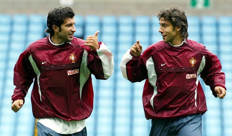 BIRMINGHAM, UNITED KINGDOM: Portugese players Luis Figo (L) and Rui Costa (R) share a joke 06 September 2002, during training at Villa Park in preparation for tomorrows friendly International against England. AFP PHOTO GERRY PENNY (Photo credit should read GERRY PENNY/AFP via Getty Images)